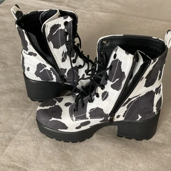 Hard to find faux suede caw print lace up and zipper boots.