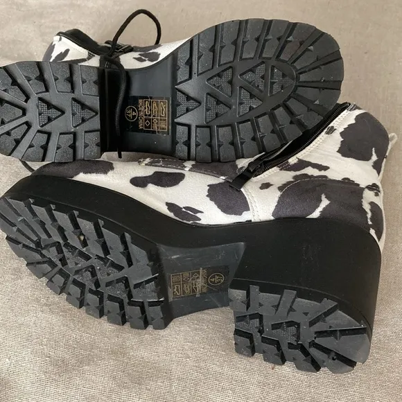 Hard to find faux suede caw print lace up and zipper boots.