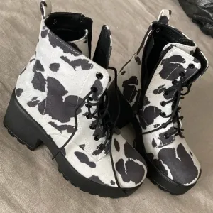 Hard to find faux suede caw print lace up and zipper boots.